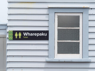 Fototapeta premium A toilet sign in Maori native language of New Zealand. Wharepaku. Male and Female