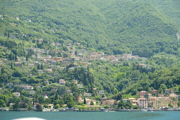 Como Lake landscape. Cernobbio village, trees, water and mountains. Italy, Europe.