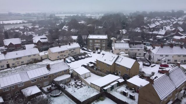 Flying over a Wiltshire village in winter after heavy snow