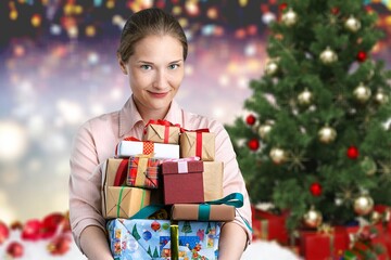 Fototapeta na wymiar Young woman holds Christmas gift boxes