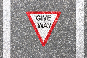 Give Way Traingle symbol painted on road is Sameer sign for movement of vehicles.