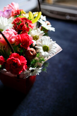 beautiful bouquet of different flowers close-up on a dark background - 553626571