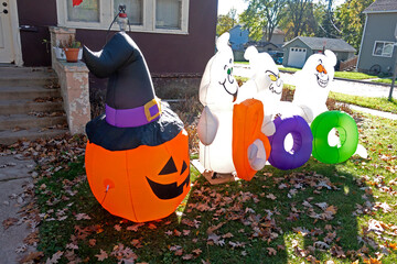 Diabolic group of blow-up ghosts and jack-o'-lantern Halloween decorations. Fergus Falls Minnesota MN USA