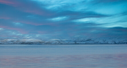 Panoramic view at fjord with coast of the Norwegian Sea, snowy mountains in the background   Arctic Circle at sunset - Norway