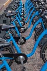 Fototapeta na wymiar Row of bicycles on the docking station, public bike-sharing mobility system