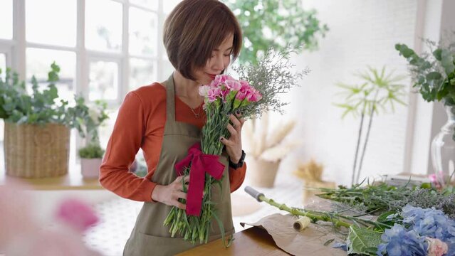 Startup successful sme small business entrepreneur owner asian woman standing table with flowers at florist shop service job. Portrait of asian girl successful owner environment friendly banner