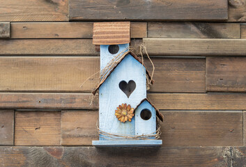 Birdhouse or roost box on the wooden wall of a building,Care for animals