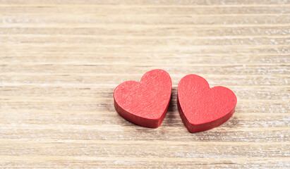 Obraz premium Two red handmade wooden carved hearts on wood background,couple relationship Valentine day concept