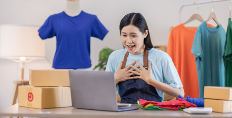 Portrait of young attractive Asian female owner startup business work happy with box at home prepare parcel delivery in sme supply chain, procurement, omnichannel commerce SME online concept.