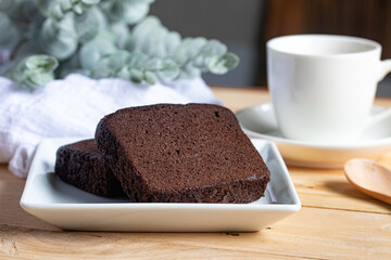 Chocolate cake with coffee in a white plate
