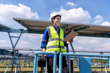 Maintenance engineer at solar farm stand on scissor lift hold check sheet inspection solar panel