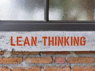 Brick wall with text inscription LEAN THINKING, concept o  the way of  thinking about creating...