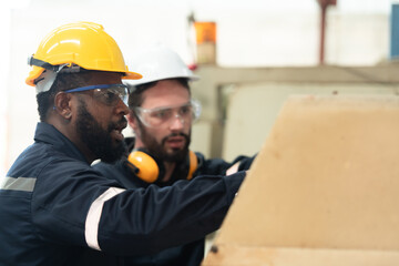 Both of engineers are consulting and exchanging repair experience with each other.