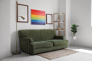 Interior of living room with sofa, frames and rainbow painting