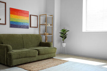 Interior of living room with sofa, frames and rainbow painting