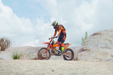 Fototapeta na wymiar Young man practice riding dirt motorcycle. Splashing sand