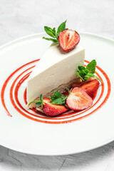 delicious homemade strawberry cheesecake with fresh strawberries, jam and mint