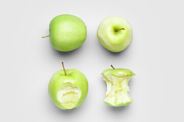 Fresh green apples and core on white background
