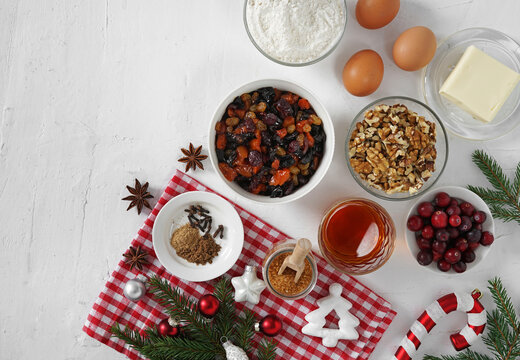 Ingredients for Christmas fruit cake ,nuts and dried fruits. Nuts and soft fruits soaking up added brandy in the ceramic bowl. Top view. copy space