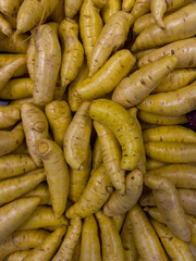 Fresh yellow baroa potatoes in the supermarket. Vegetables and fruits exposed for consumer choice. Brazilian hortifrutti. Top view