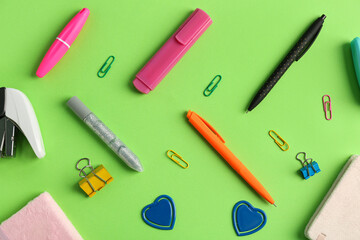 Composition with different stationery on green background