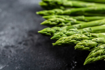 bunch of fresh asparagus on dark background, Pickled Green Asparagus. place for text, top view