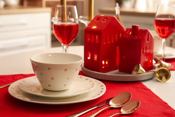 Christmas table setting with candle holders in kitchen, closeup