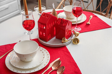 Christmas table setting with candle holders in kitchen, closeup