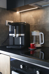 Coffee maker and electric tea kettle on the kitchen counter, modern domestic living concept.