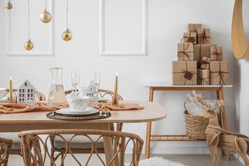 Table setting with candle holders and Christmas balls in dining room