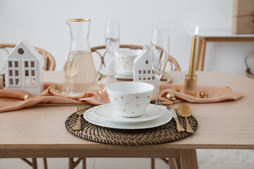 Table setting with candle holders and Christmas balls in dining room, closeup