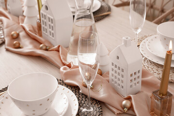 Table setting with candle holders and Christmas balls in dining room, closeup