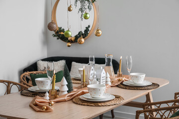 Table setting with candle holders and Christmas balls in dining room