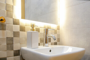Bathroom sink with ceramic soap dispenser, mozaic ceramics and mirror with back light