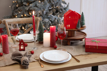 Table setting with candles and Christmas balls in dining room