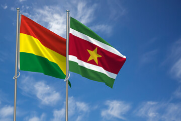 Plurinational State of Bolivia and Republic of Suriname Flags Over Blue Sky Background. 3D Illustration