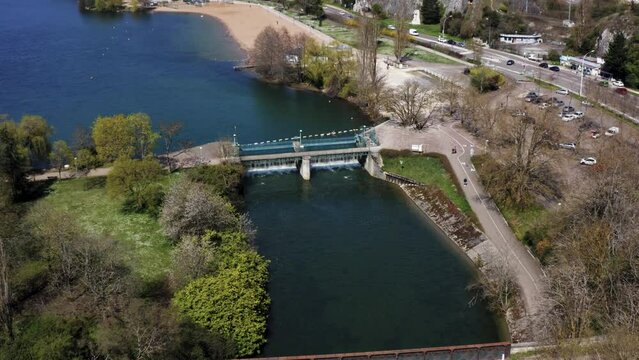 Urban lake with footbridge and clean water energy (4k 30p Drone)
