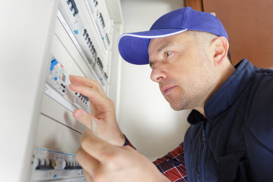 focused electrician by central fusebox
