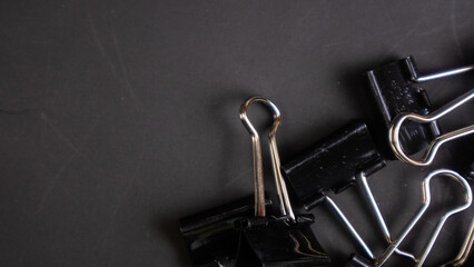a black paper clip on a black background