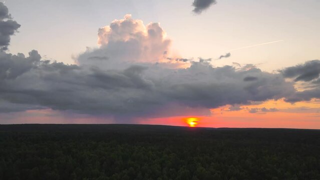 Sunset with golden light on a beautiful dark sky. Time lapse, evening sky at sunset. Weather, cloudy nature background, time lapse. Video, footage for transition or intro. UHD 4K.