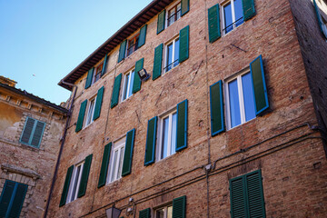 Fototapeta premium Traditional window blinds on a building in Italy