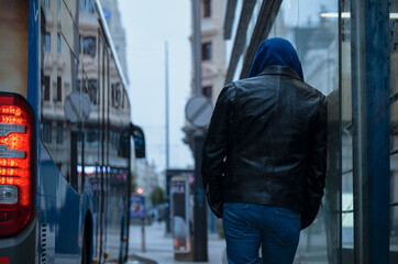 Adult man standing on street aside bus. Madrid, Spain