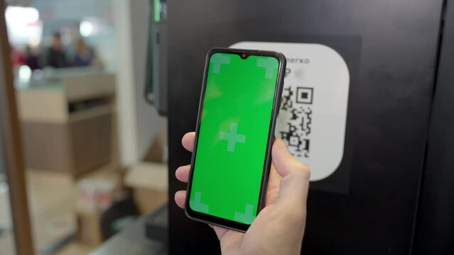 A man scans a QR code