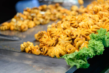 a lot of grilled squid in tray