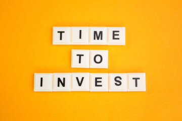 letters of the alphabet with the word Time to invest. the concept of time to invest. investment concept
