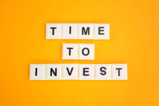 letters of the alphabet with the word Time to invest. the concept of time to invest. investment concept
