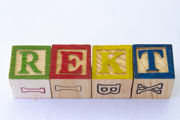 The term REKT visually displayed on a clear background with copy space