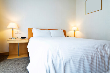 White bed sheet and pillows in hotel room