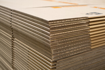 Stack of new Disassembled condition packaging corrugated carboard boxes. lot of cardboard packaging. not folded. Production distribution concept.