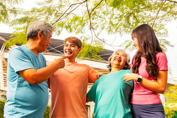 Happy asian family : Elderly parents and son daughter having fun chatting preparing for marathon training in the park around the stadium on a sunny morning : Health care concept.